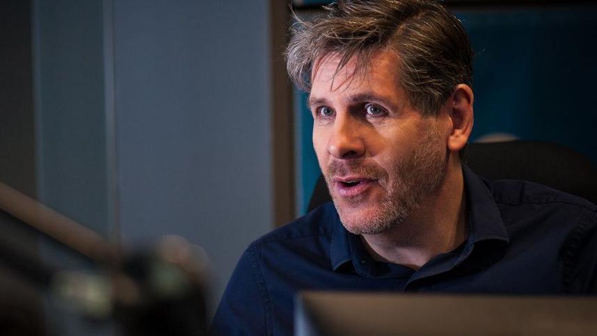 Tony Livesey broadcasting in a radio studio