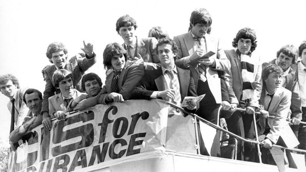 Swansea players on an open-topped bus after their promotion in 1981