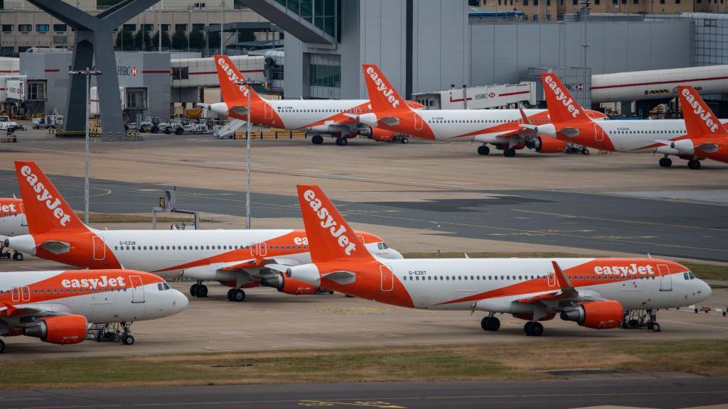Easyjet planes on the tarmac at Gatwick airport.