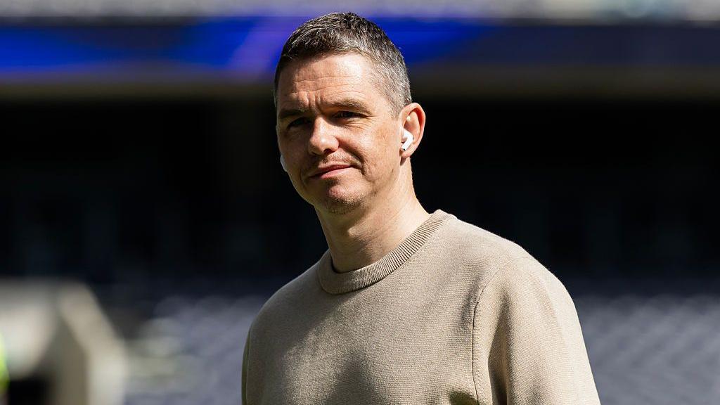 Close up image of Marc Skinner wearing in-ear headphones