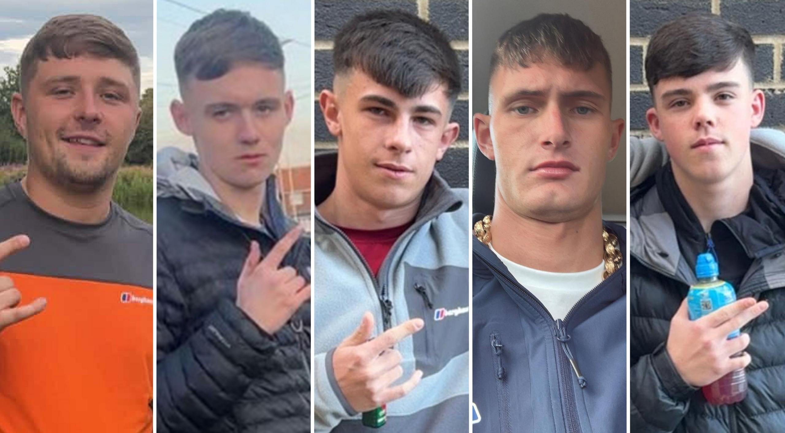 Five young men in their late teens and early 20s. They all have similar haircuts, with a fringe and faded back and sides. Four of them are gesturing with their fingers. Three of them extend their thumb, index, and pinky fingers - leaving their middle and ring finger tucked down. One points with his index and middle finger whilst holding a Lucozade bottle. They are all dressed in casual clothing.