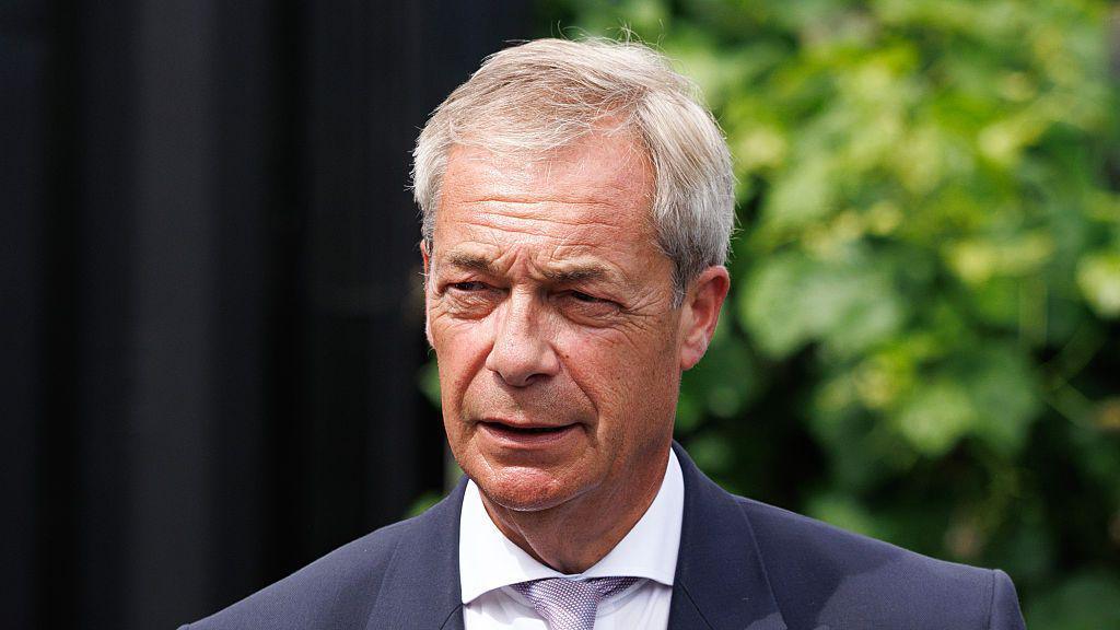 Nigel Farage wearing a suit and tie.