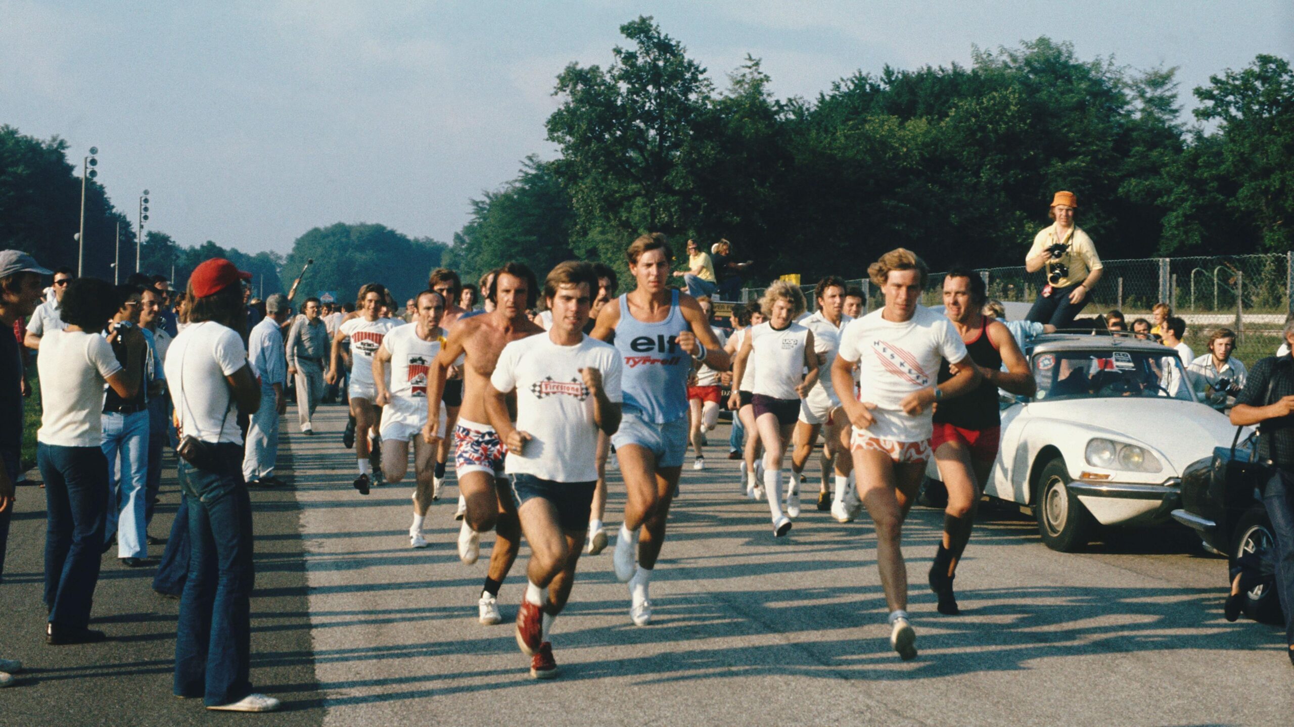 Drivers and team members take part in a track run at the 1973 Italian Grand Prix