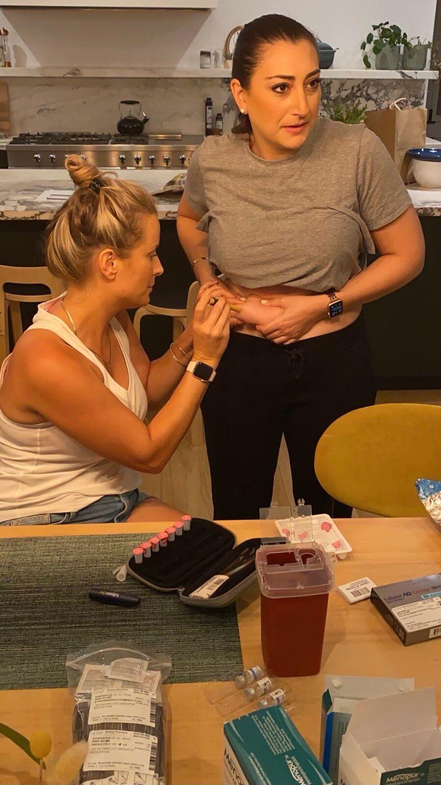 Congresswoman Sara Jacobs injects herself with the help of a friend