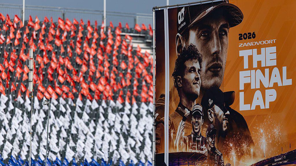 Individual flags are laid out on each seat of the grandstand to create a larger image of the Dutch flag with the race poster