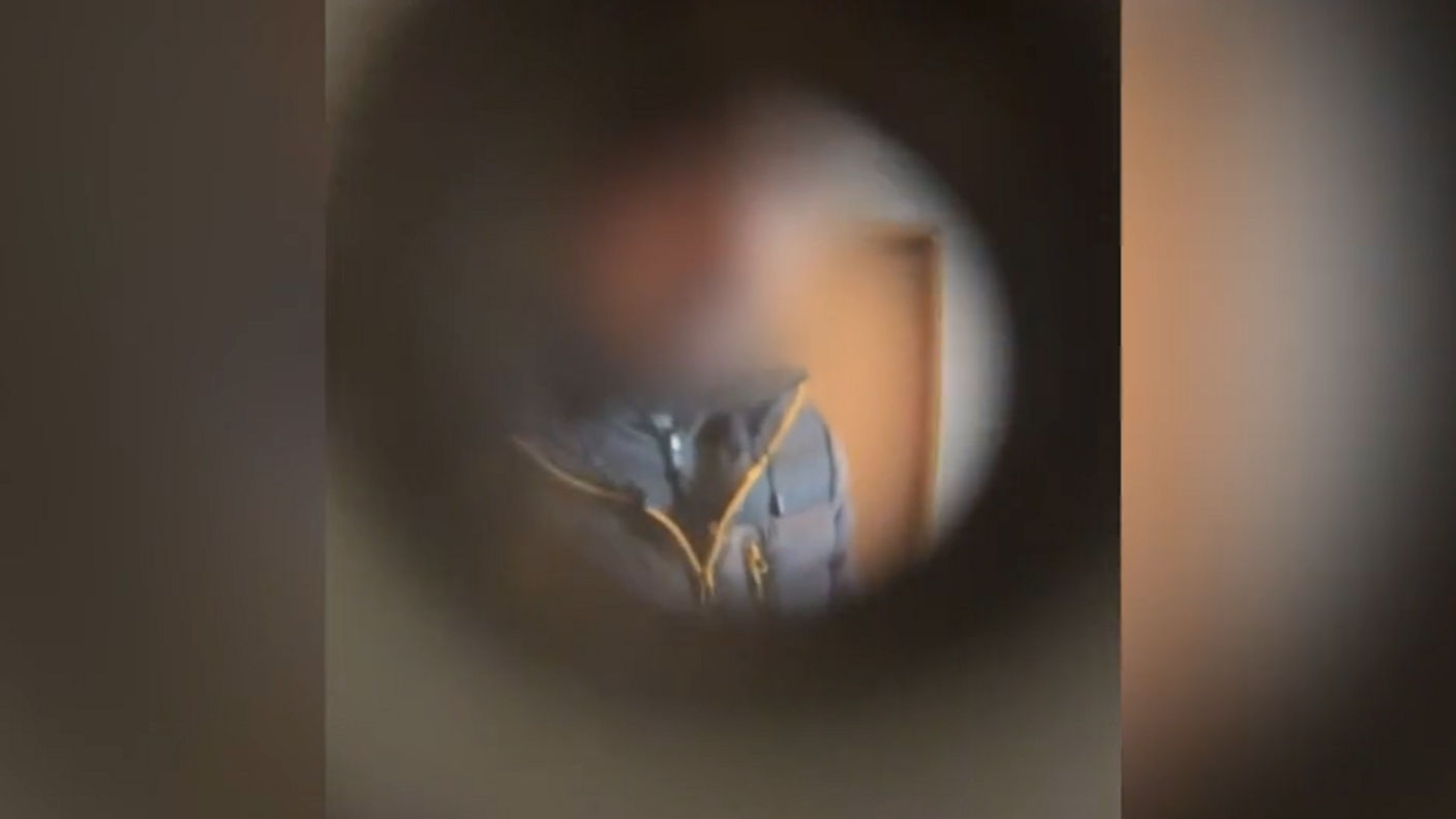 A still image taken from mobile phone footage of Lucy's attacker through the Travelodge room peephole