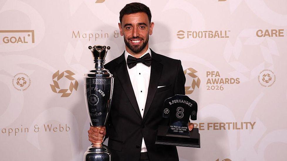 Manchester United's Portuguese player Bruno Fernandes poses with the Men's PFA Players' Player of the Year award
