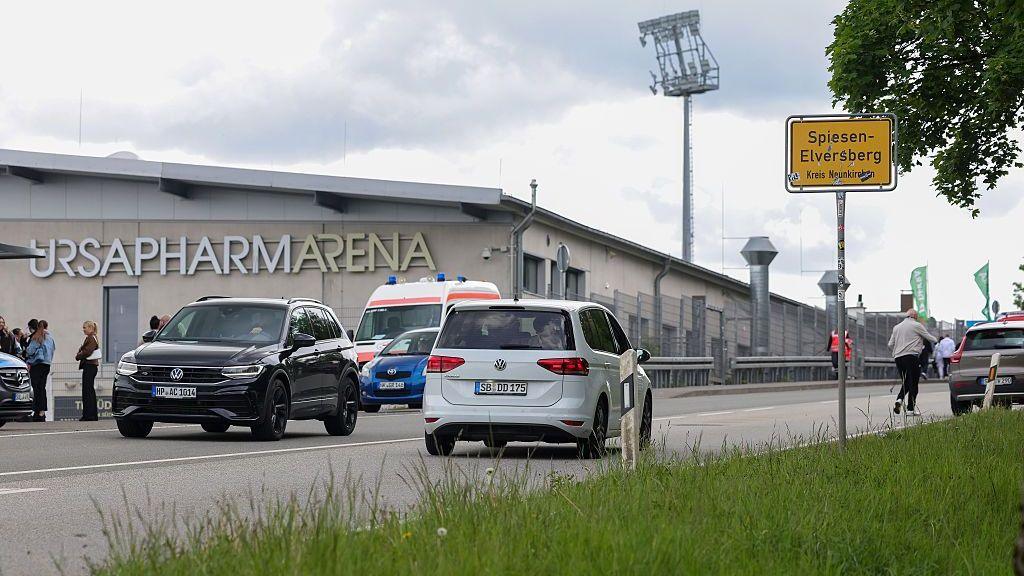 A general view of Elversberg's stadium from the outside, next to a main road with cars