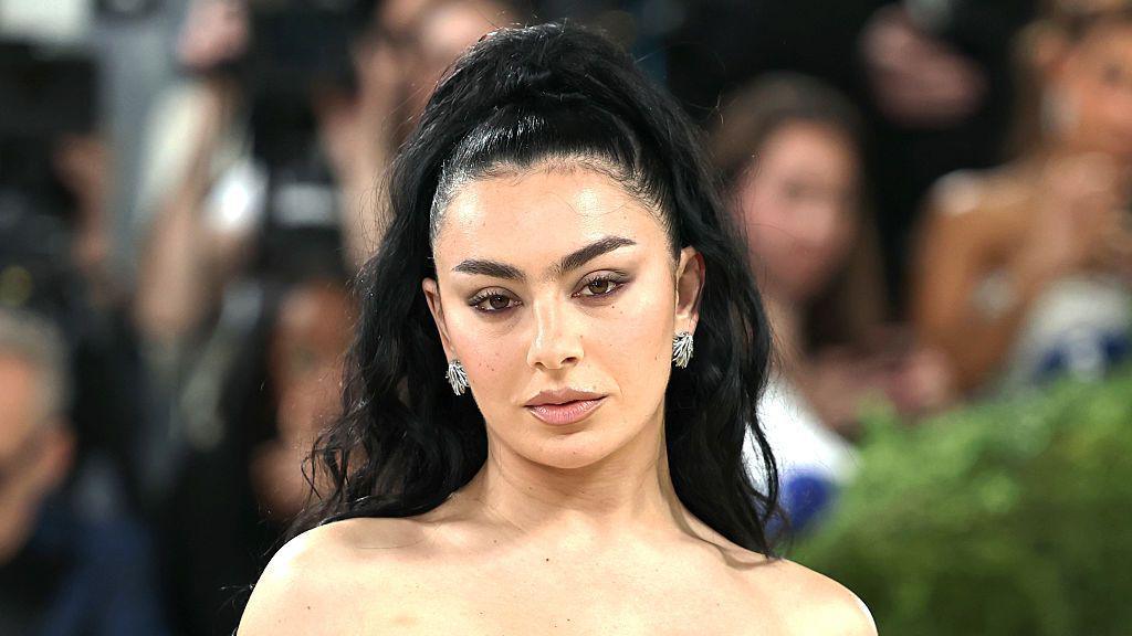 A picture of Charlie XCX at the Met Gala in New York. Her black hair is tied up.
