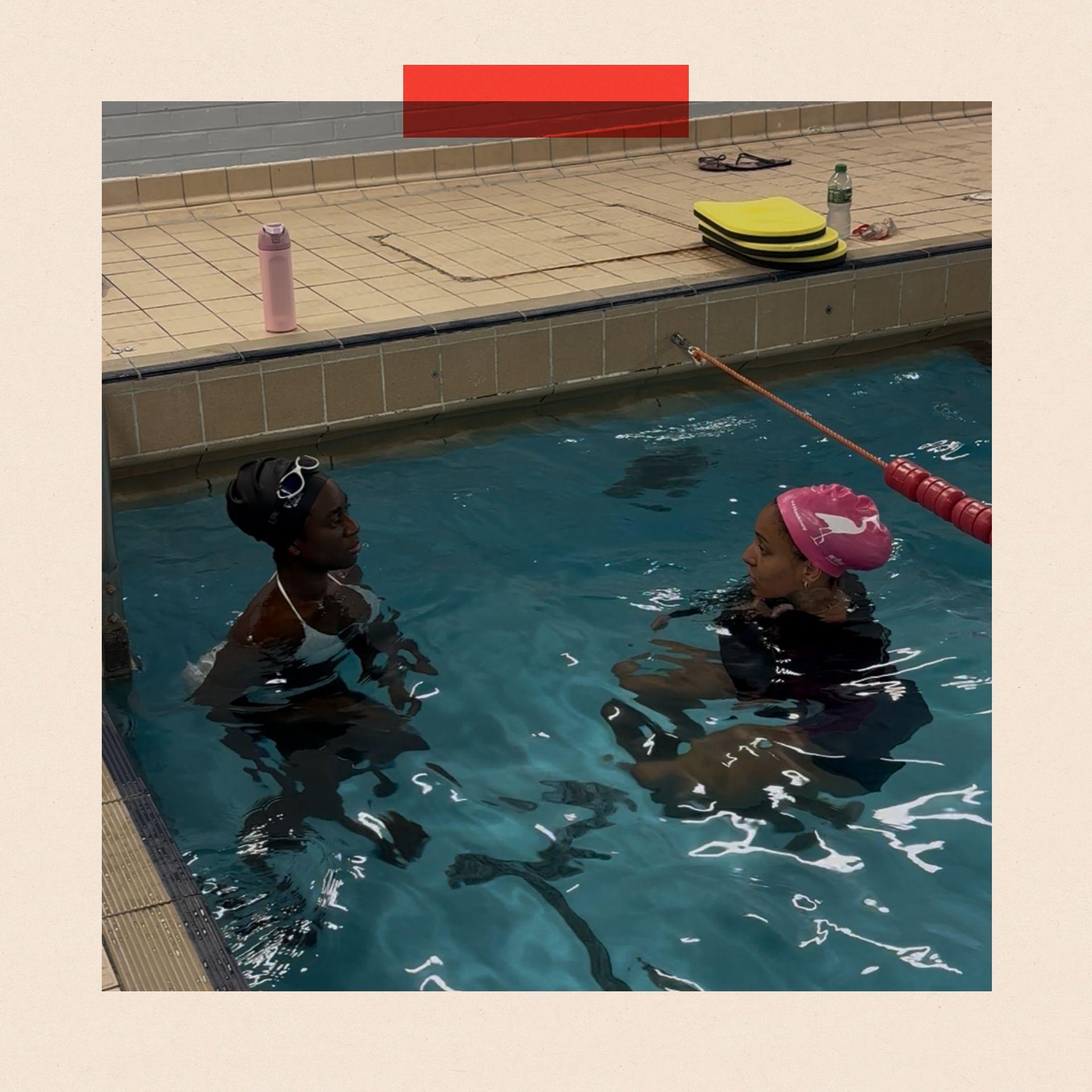 Florence Freeman listens as Omie Dale teaches her techniques for swimming