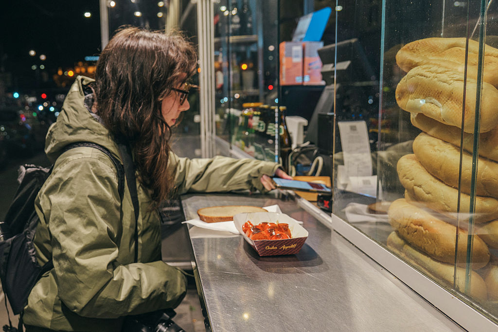 Tourist paying with her phone with Apple Pay