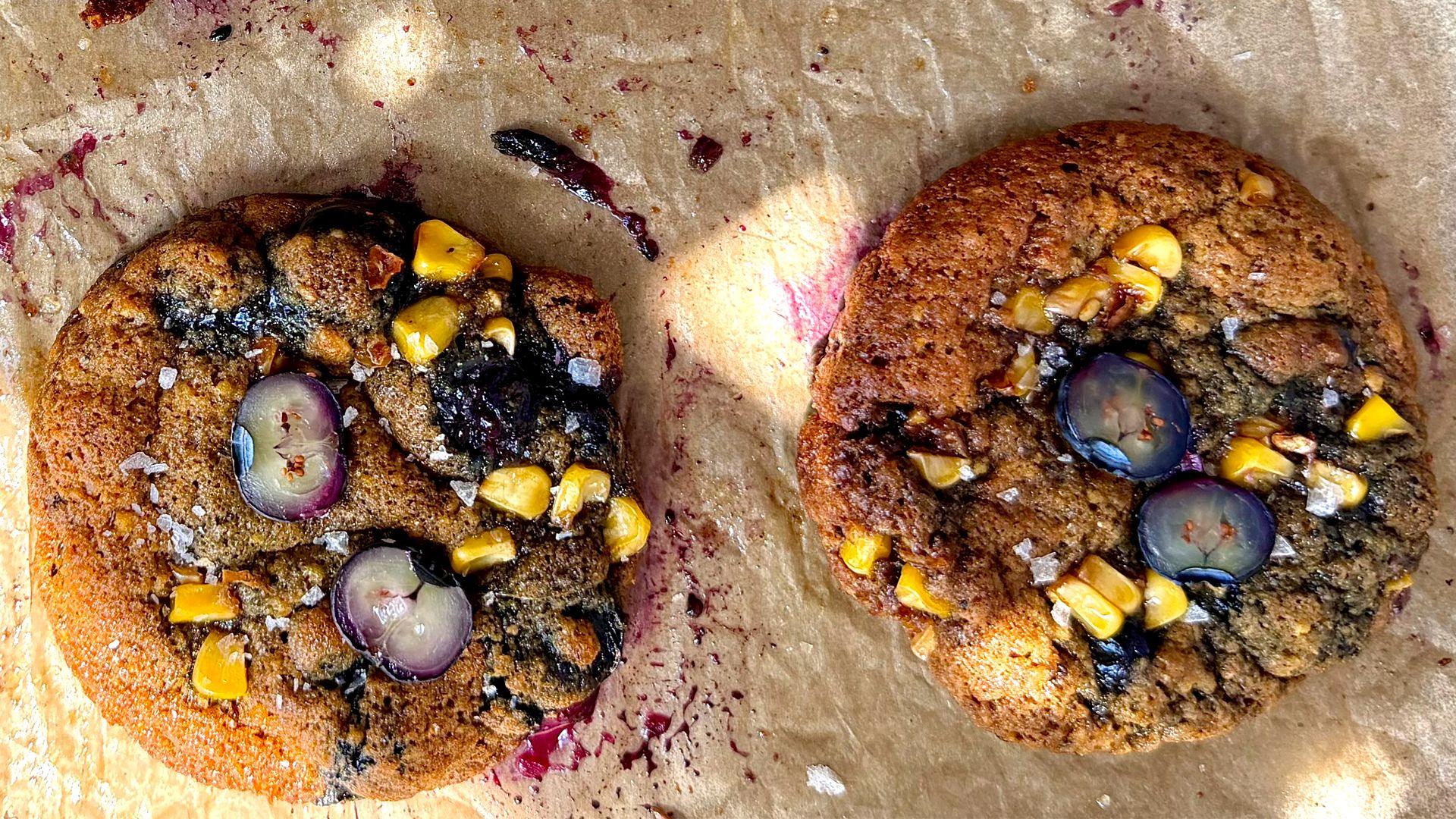 Two homemade cookies with sweetcorn and blueberries on top