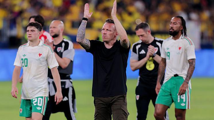 Wales boss Craig Bellamy applauds