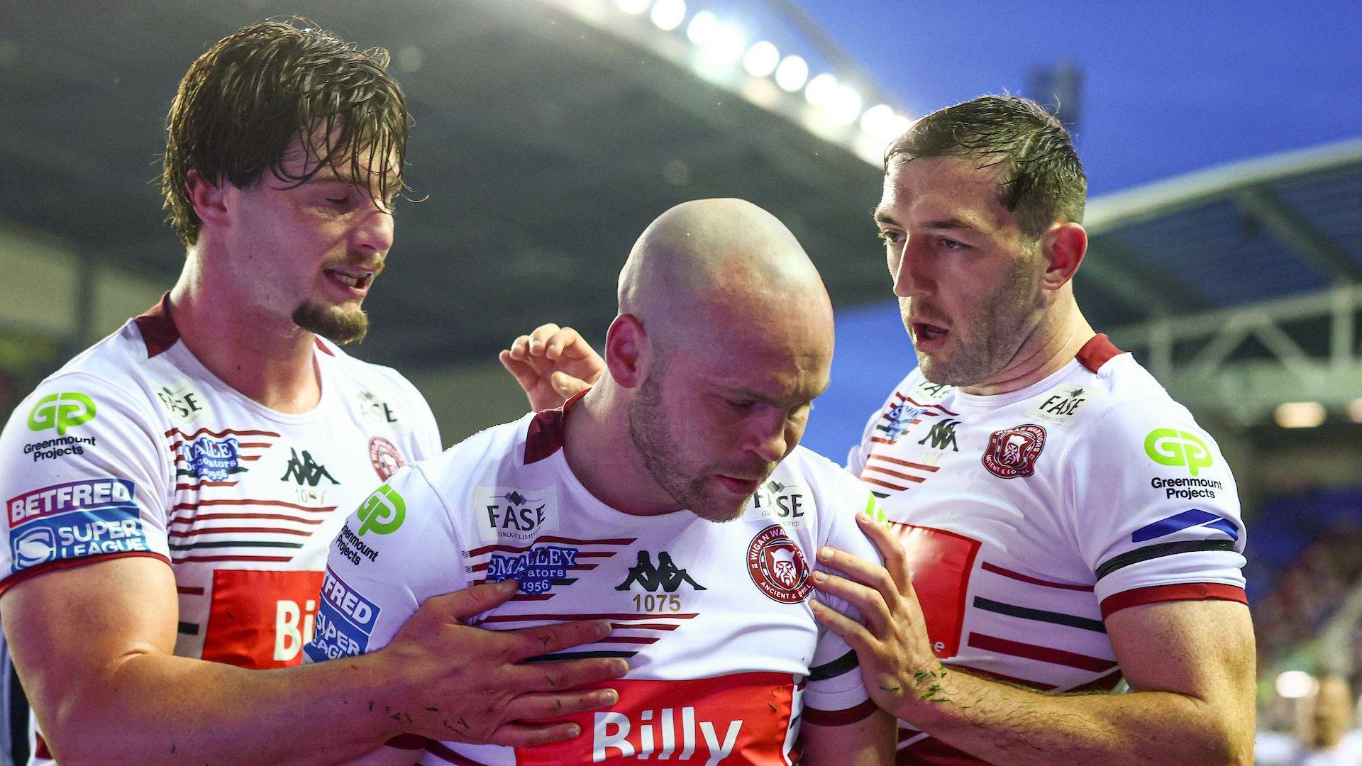 Liam Marshall (centre) celebrates scoring one of his tries for Wigan Warriors