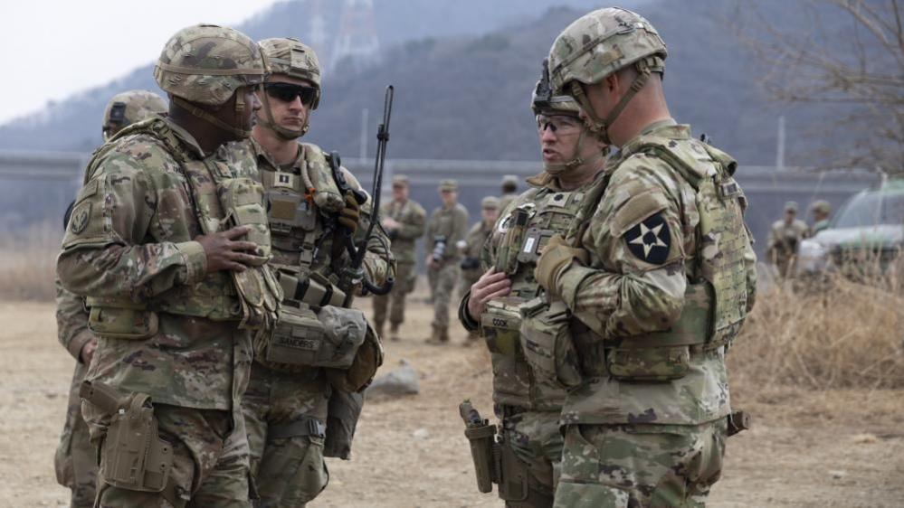 Four US soldiers meet during an exercise