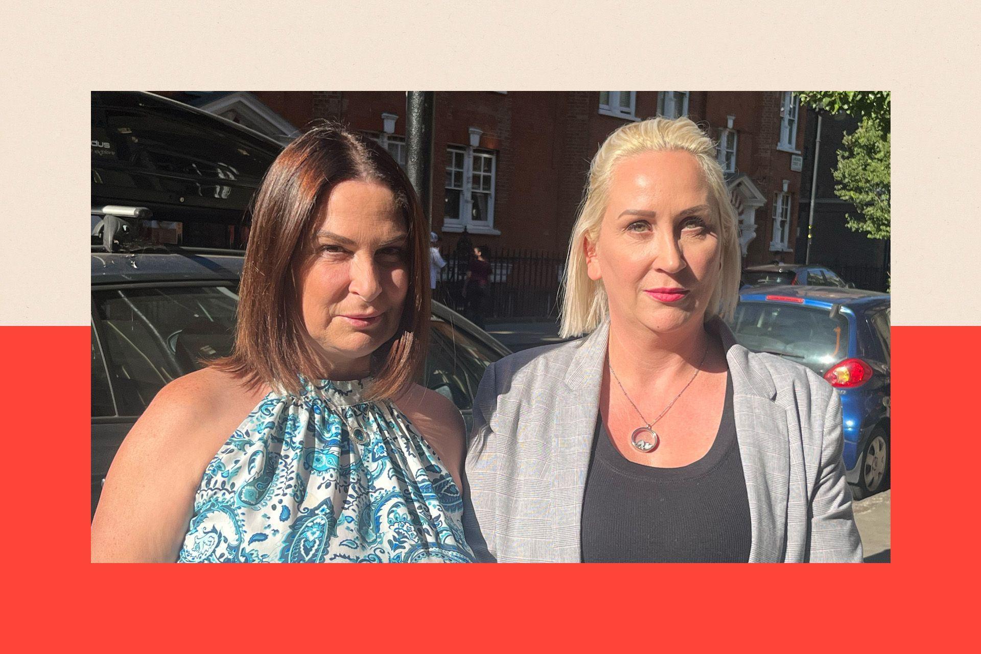 Two women standing on a street outdoors