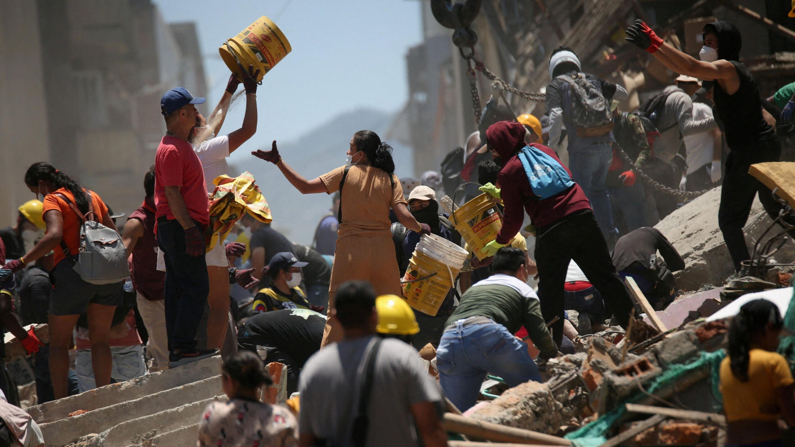 People handle rubble at the site of a damaged building following an earthquake in Pereira, Colombia
