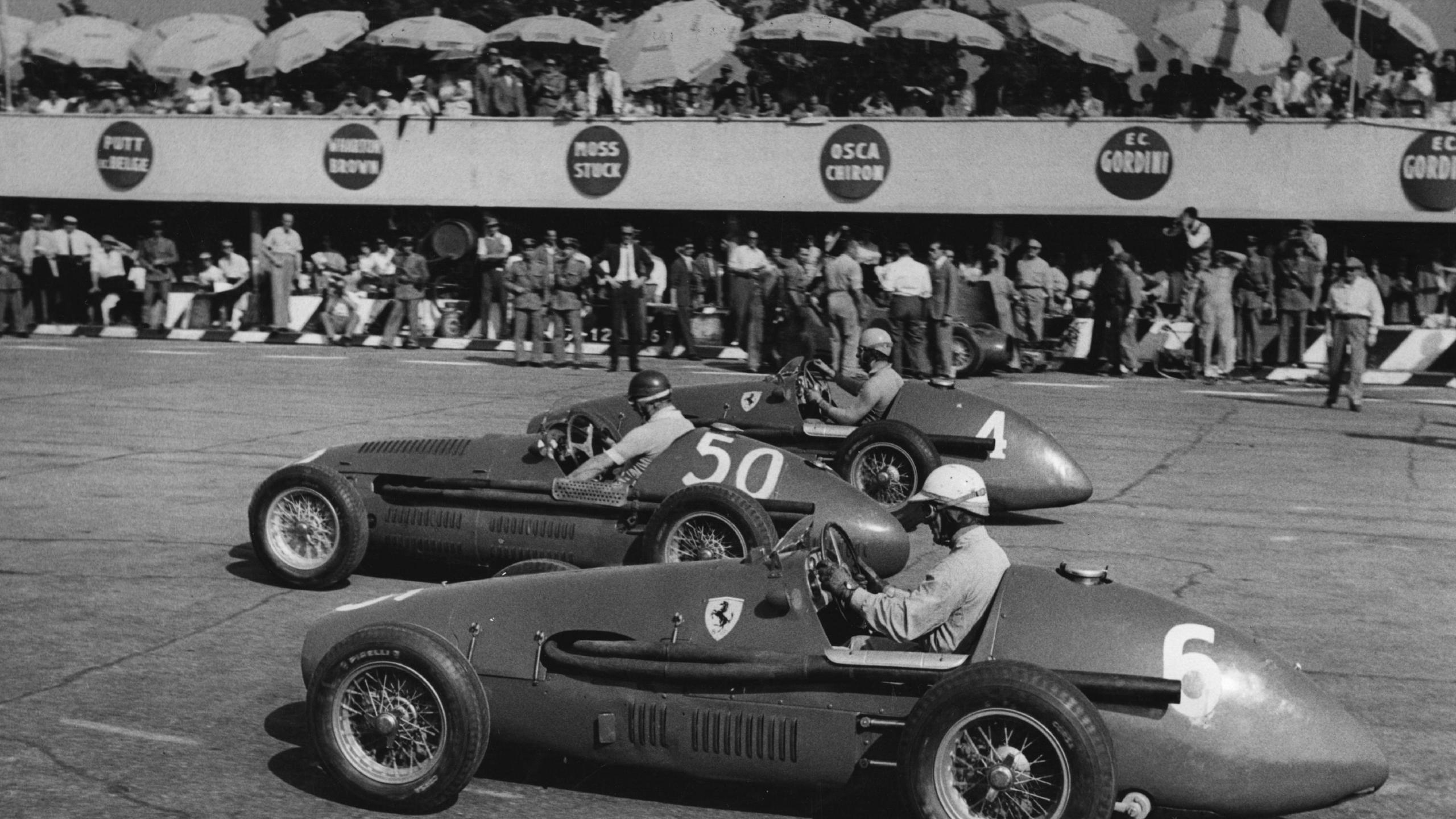 Ferrari's Giuseppe Farina (nearest the camera), Maserati's Juan Manuel Fangio and Ferrari's Alberto Ascari on the far side line up before the start of the 1953 race