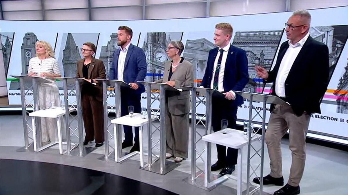 The candidates for Greater Manchester mayor stand behind lecterns in a TV studio