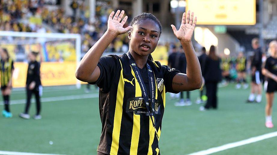 Monica Jusu Bah waving to the crowd while wearing a BK Hacken kit
