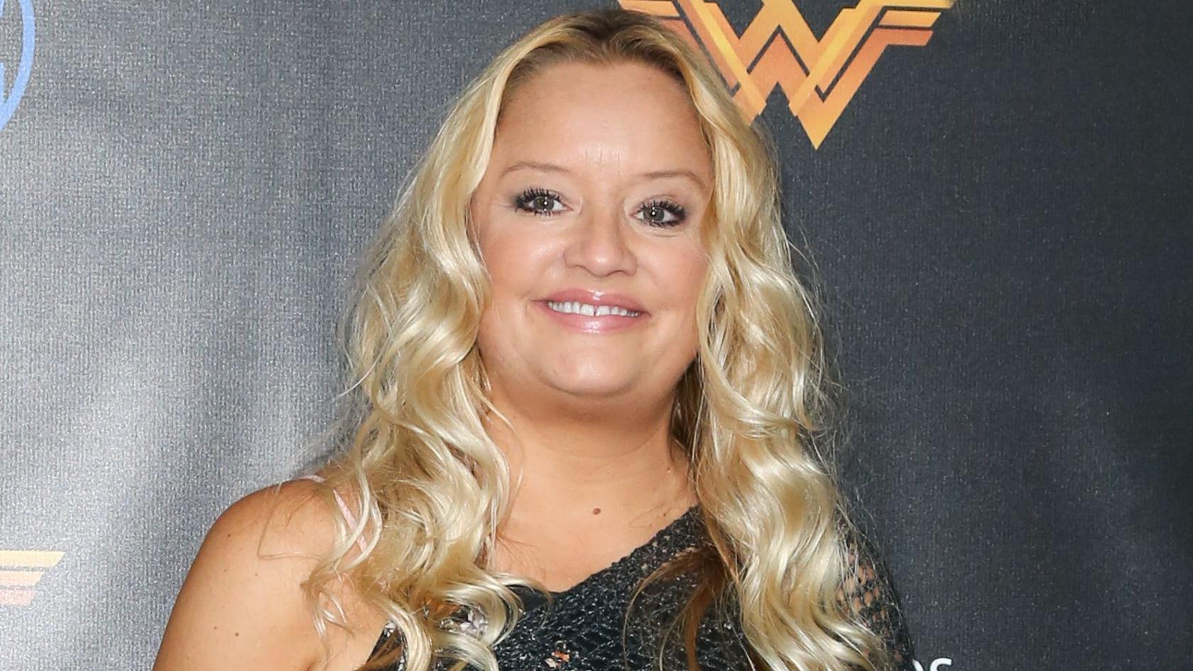 Davis smiling at the camera in front of a Wonder Woman logo at the opening of the Wonder Woman Behind-The-Scenes Experience at Warner Bros Studios on July 31, 2017 in Burbank, California