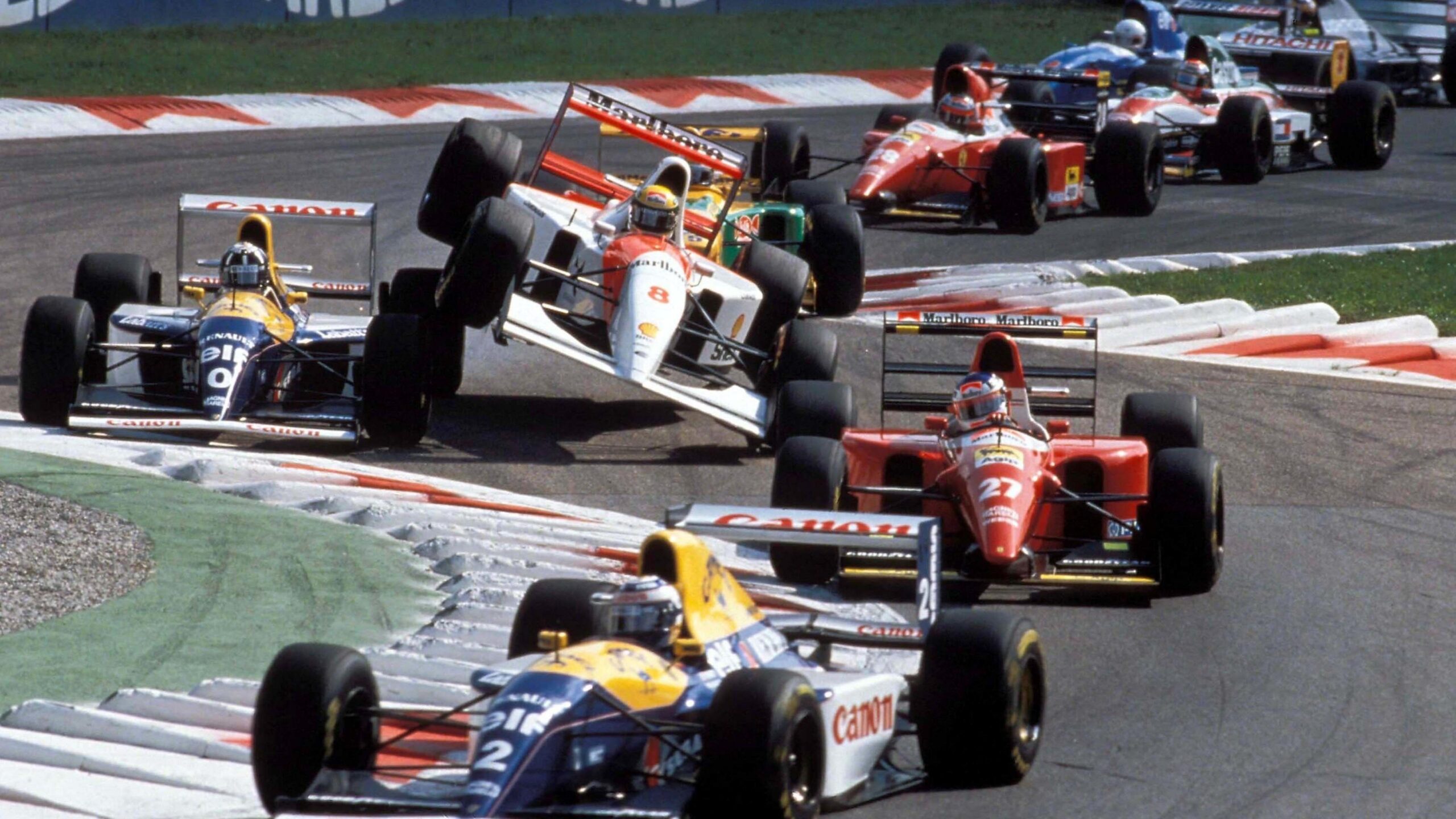 The McLaren of Ayrton Senna is thrown up into the air after colliding with the Williams of Damon Hill going through the first chicane at the 1993 Italian Grand Prix