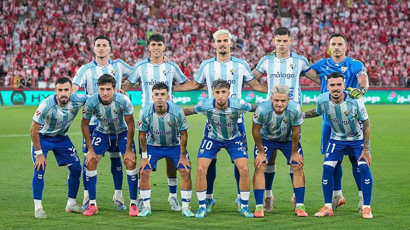 Malaga line up before playing Almeria