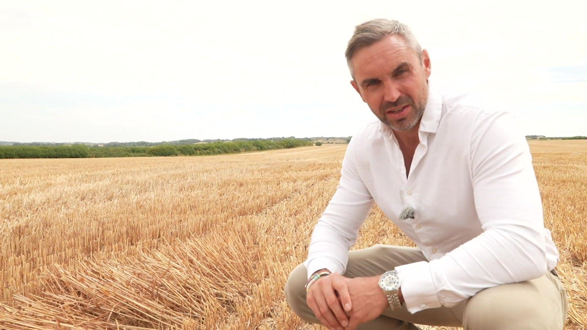 Tomos Morgan stood in a dry wheat field