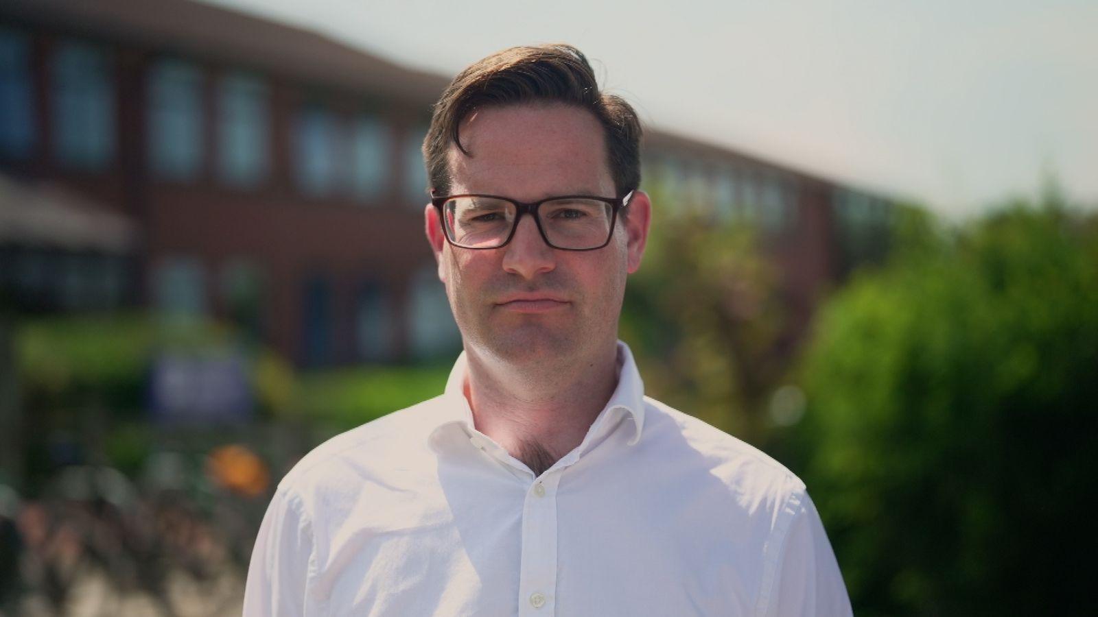 Nick Wakeling, a teacher at Colyton Grammar School, is wearing glasses and a white shirt and looks straight at the camera.
