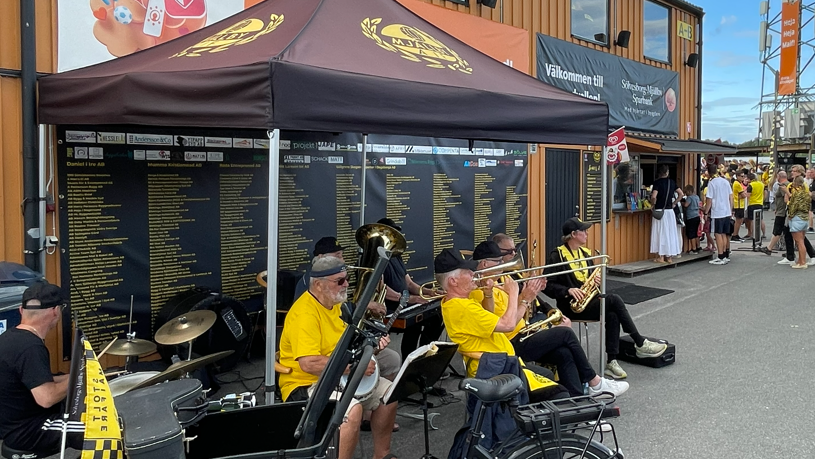 A jazz band plays at Strandvallen during Mjallby's Champions League game at home to Lincoln Red Imps in 2026