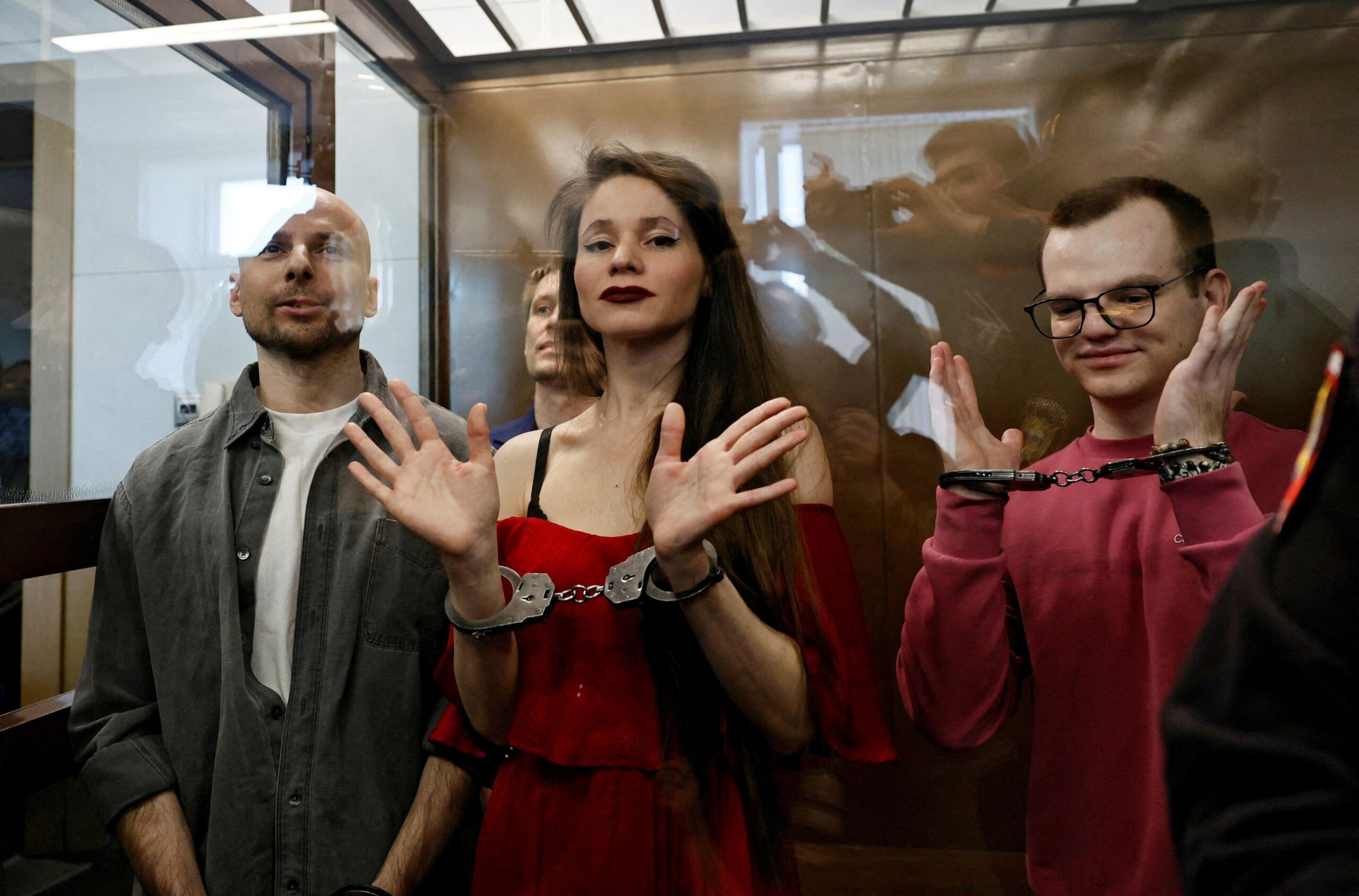 Antonina Favorskaya, Konstantin Gabov, Sergey Karelin and Artyom Kriger  are handcuffed and standing in the dock during their trial.