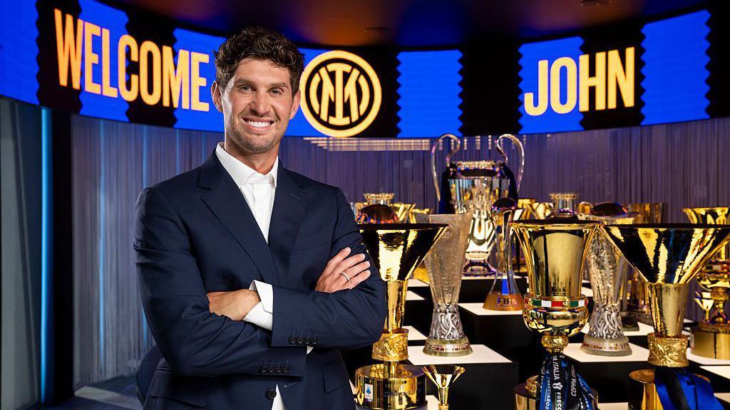 John Stones next to some of the trophies Inter Milan have won