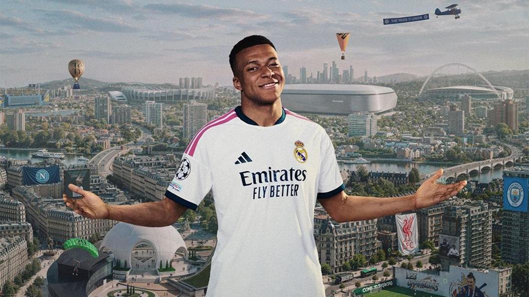 Kylian Mbappé is pictured wearing his Real Madrid strip, smiling, in front of a cityscape backdrop featuring dozens of references to different football teams and players. Flags for Manchester City and Liverpool and a mural depicting Zlatan Ibrahimovich are among the immediately obivious references..