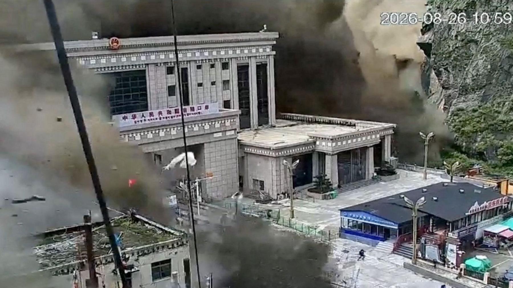 CCTV shows people running as mud and water destroys buildings in Gyirong, Tibet