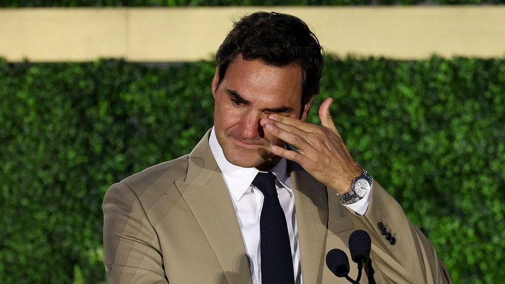 Roger Federer wipes away tears at the International Tennis Hall of Fame