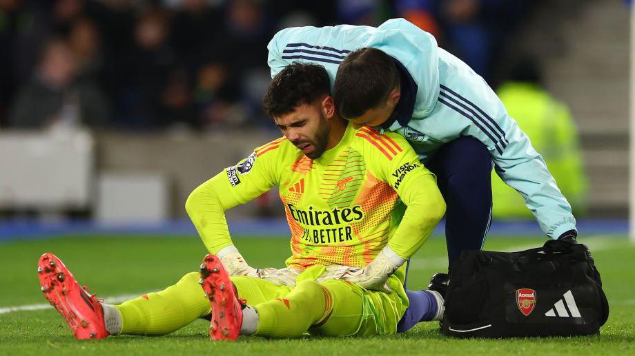 David Raya of Arsenal goes down injured during the Premier League match against Arsenal