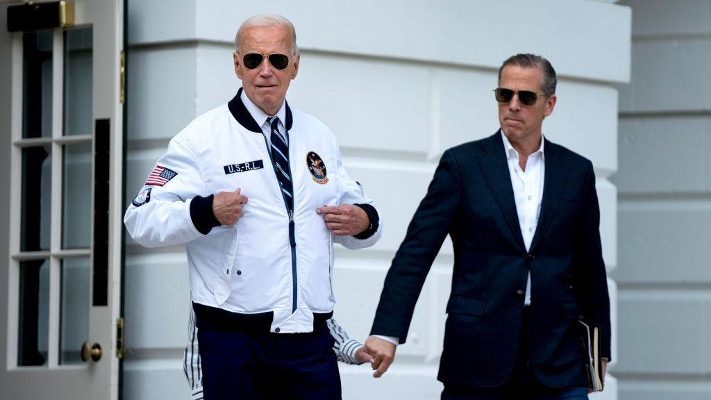 Hunter Biden, son of US President Joe Biden, right, watches as US President Joe Biden gestures to his "Team USA" jacket on the South Lawn of the White House before boarding Marine One in Washington, DC, US, on Friday, July 26, 2024.