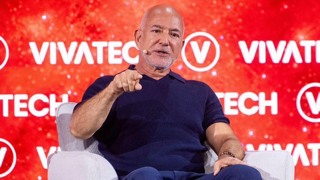Jeff Bezos, founder of Amazon, points on stage at the VivaTech conference in Paris, France