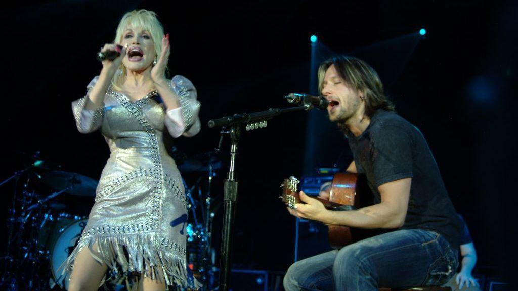 Dolly Parton and Keith Urban performing on stage