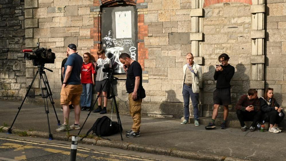 Members of the media wait outside the Special Criminal Court where alleged Irish crime gang boss Daniel Kinahan is due to appear on charges of organised criminal activity after being extradited to Ireland from the United Arab Emirates