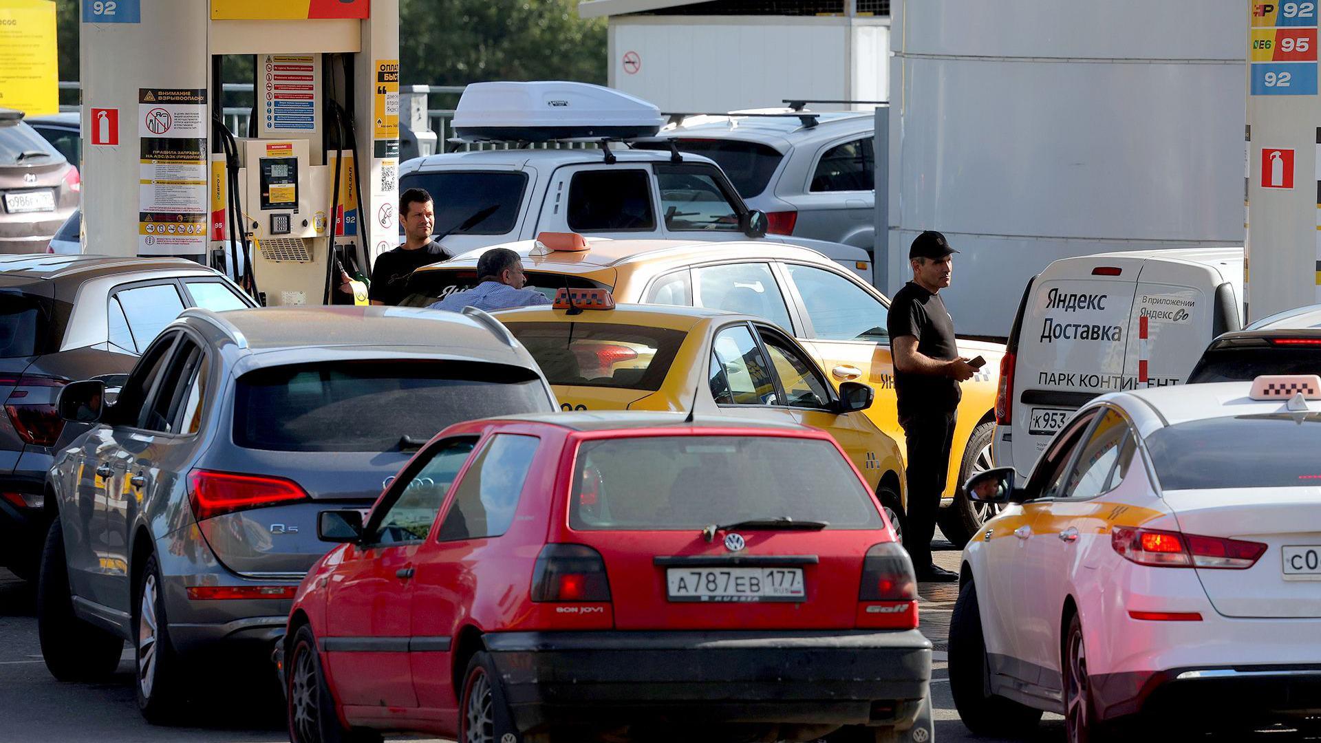 Cars line up at a petrol station in Moscow on Thursday
