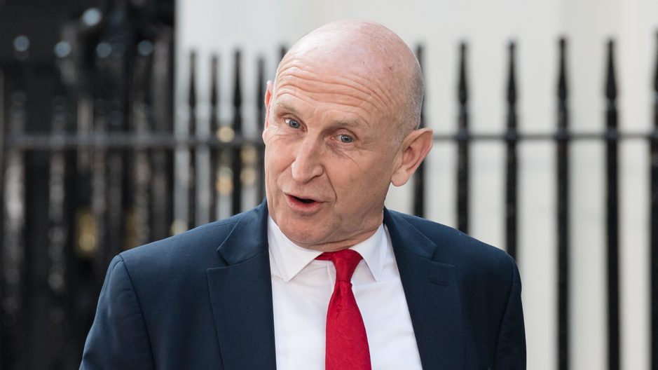 The UK's new chancellor John Healey wears a dark blue suit jacket, a white shirt and a red tie