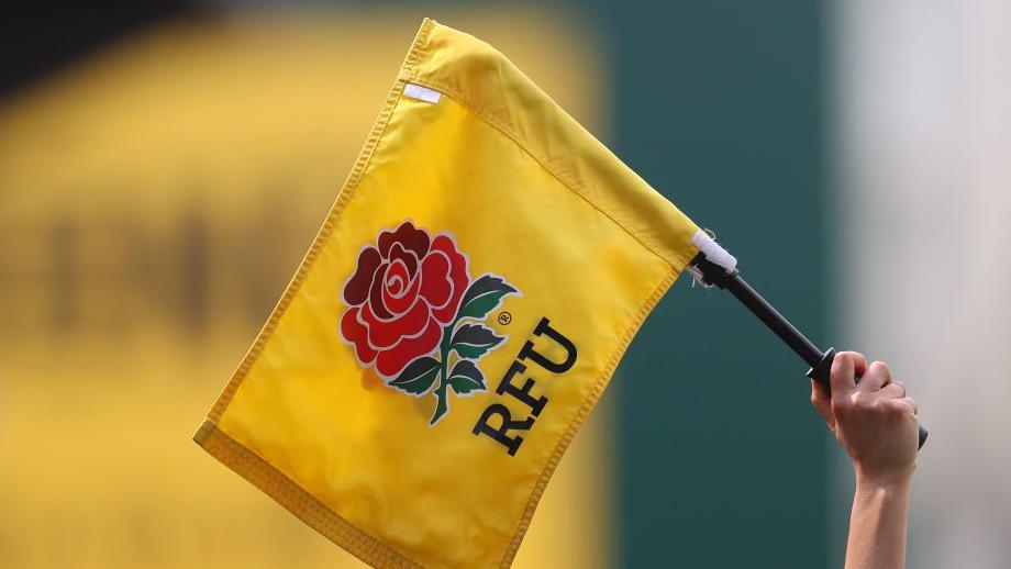 An official holds up a flag with the RFU logo on during the Women's Six Nations match between England and Ireland in Leicester in April 2022