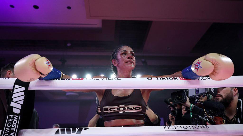 Amanda Serrano leans over the ropes after a fight