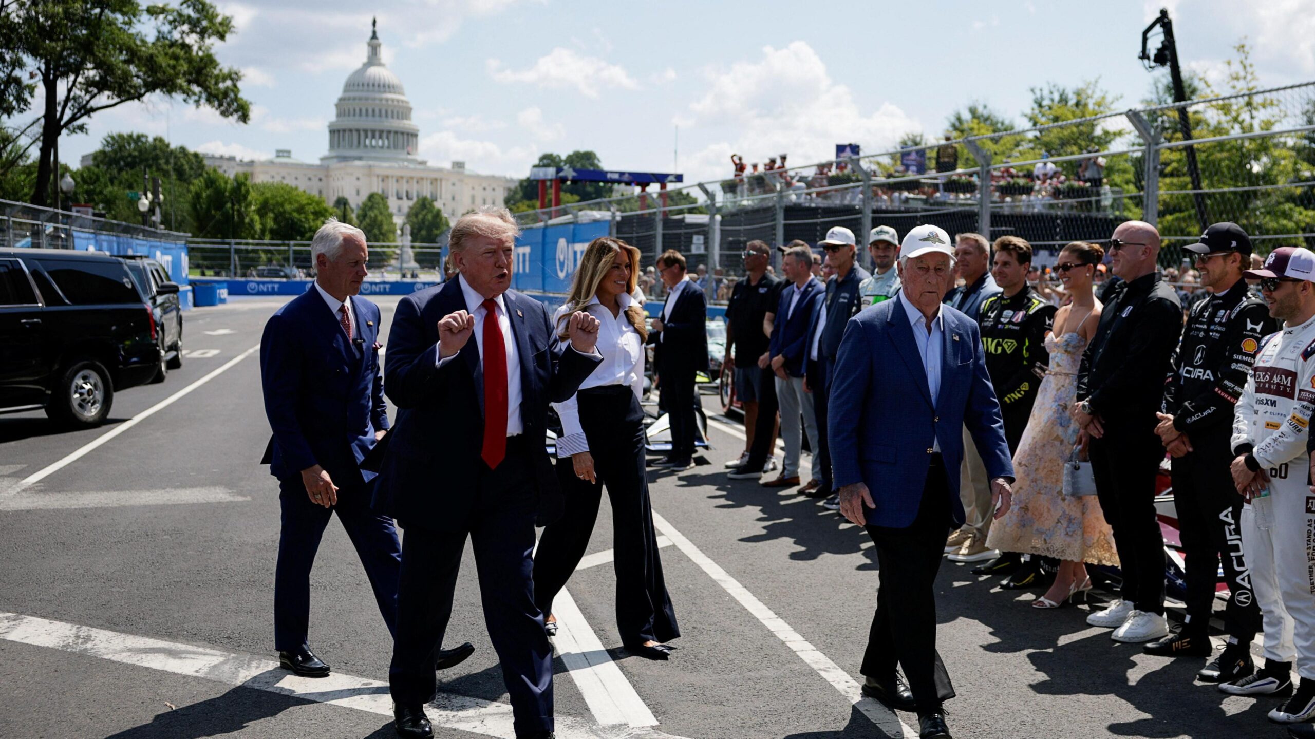Donald Trump holds up his fists as he arrives at the event