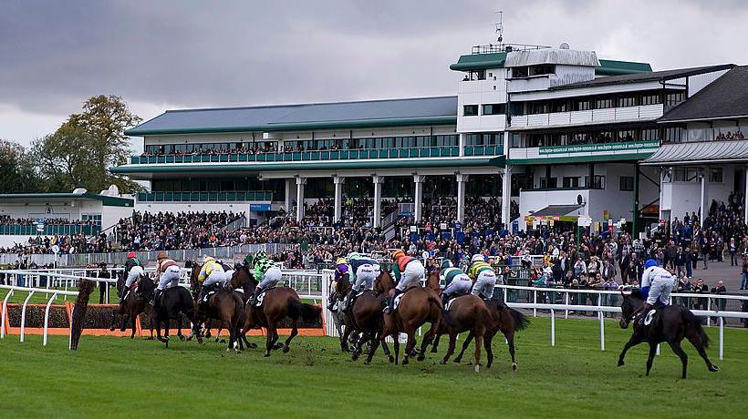 Runners take a flight of hurdles in front of the grandstand at Chepstow racecourse on October 25, 2011 in Chepstow, Wales