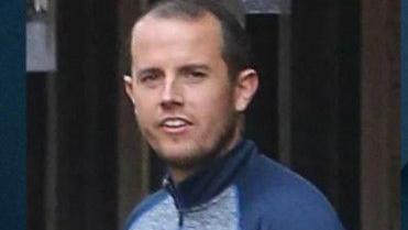 Sean McGovern is seen in a tracksuit top and has short black hair