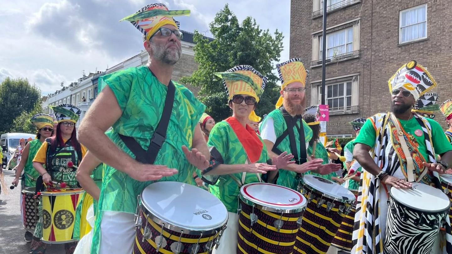 People in the parade playing drums