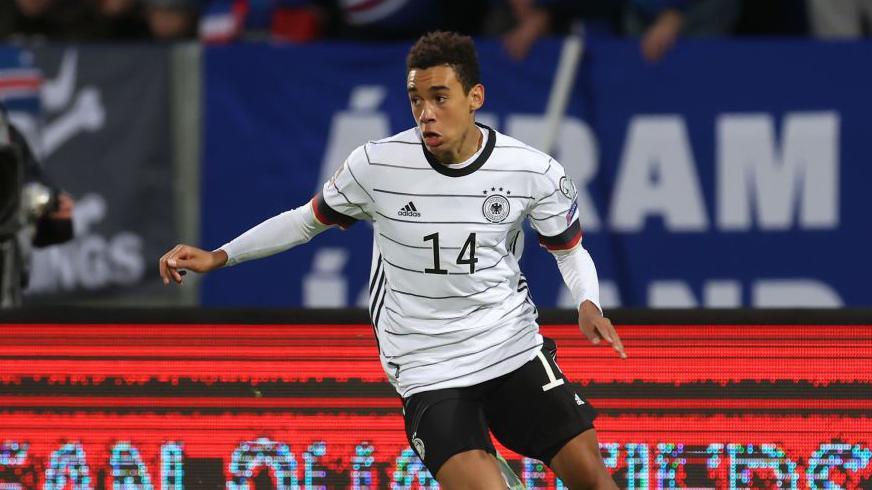 Jamal Musiala runs with the ball for Germany against Iceland in 2021