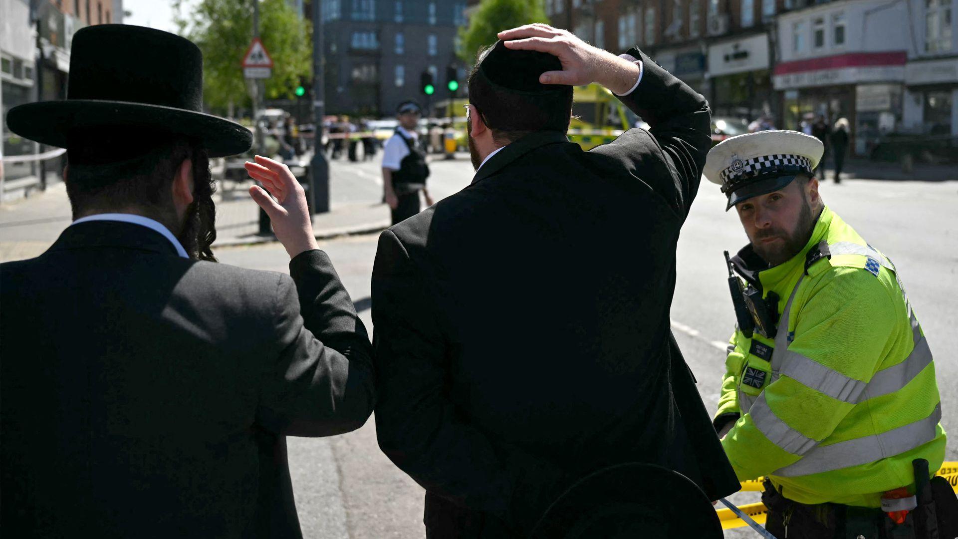 Two Jewish men and a police officer